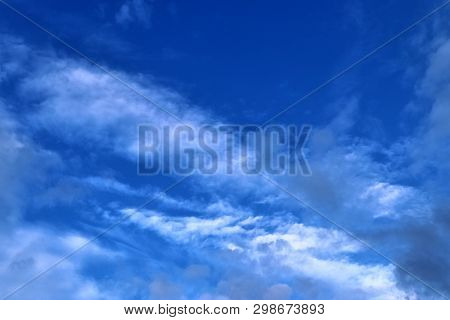 Beautiful Mixed Cloud Formations With White And Grey Cumulus Clouds In The Sunlight On A Blue Sky Se