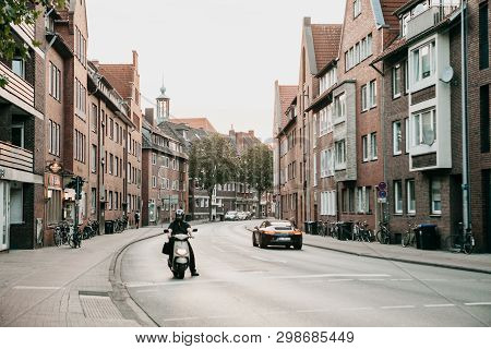 Germany, Muenster, August 17 2018: View Of The City Street. Bicycles Are Parked On The Side Of The R