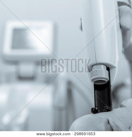 Doctor In Protective Glasses Doing Laser Removal Procedure Black White Image With A Blue Toning