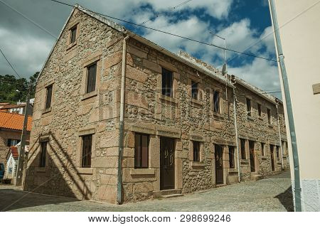 Facade Of Old Stone Two-story House With Wooden Door, In A Deserted Alley At Unhais Da Serra. A Smal