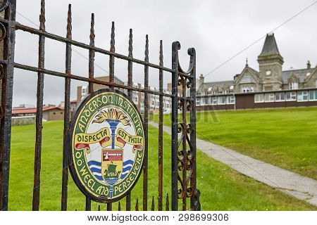 Painted Sign On Metal Doors As Entrance Into Anderson High School In Lerwick, Shetland Islands, Scot