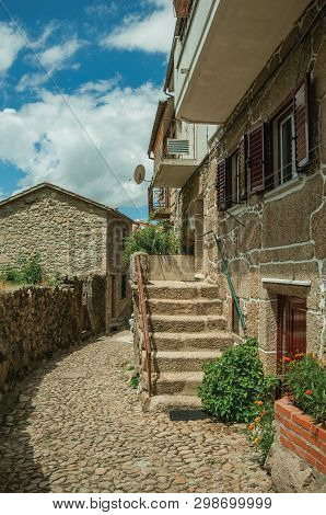 Facade Of A Neat Stone House With Staircase On A Cobblestone Alley, In A Sunny Day At Alvoco Da Serr