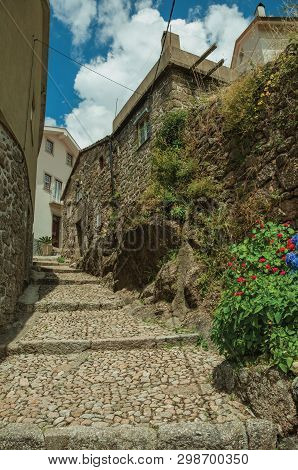 Old Stone Wall And Houses In Cobblestone Alley On Slope With Steps, In A Sunny Day At Alvoco Da Serr