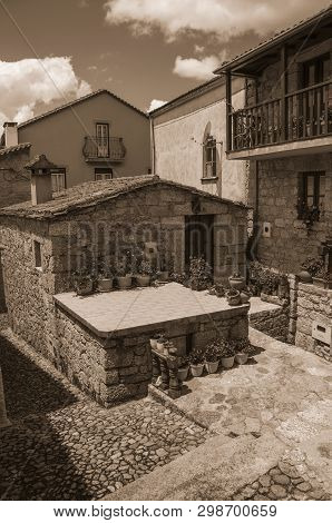 Narrow Cobblestone Alley And Stone Houses, In A Sunny Day At Alvoco Da Serra. A Cute Village Clingin