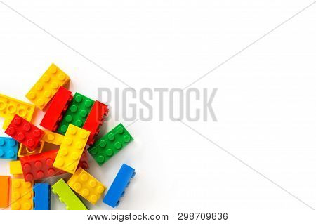 Bunch Of Colorful Plastick Constructor Bricks On White Background. Popular Toys. Copyspace