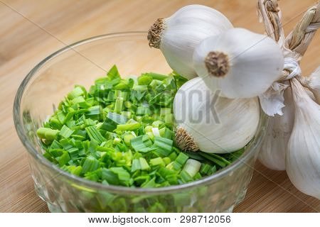 Chopped Green Garlic On Cutting Board Preparated For Cooking. Close-up Photo With Selective Focus.