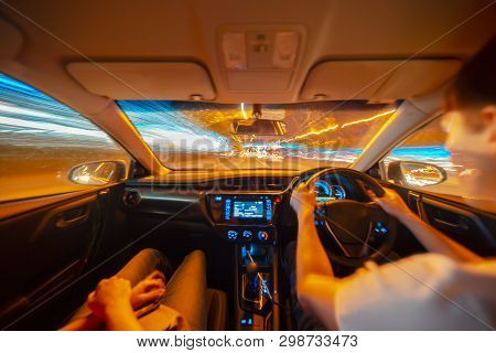 Drivers Hands On A Steering Wheel Of A Car And Woman In The Passenger Seat. Road Trip On The Austral