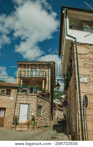 Unhais Da Serra, Portugal - July 15, 2018. Facade Of Old Houses With Stone Wall At Unhais Da Serra. 