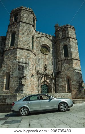 Guarda, Portugal - July 16, 2018. Car In Front Of Gothic Cathedral With Steeples, In A Sunny Day At 