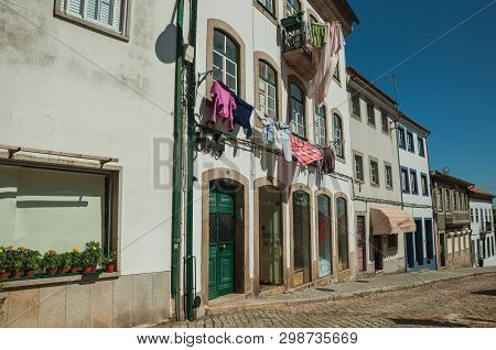 Clothes Hung To Dry In Front Of Windows On Building