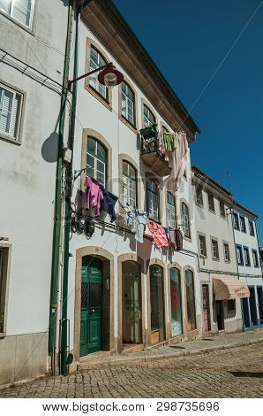 Clothes Hung To Dry In Front Of Windows On Building