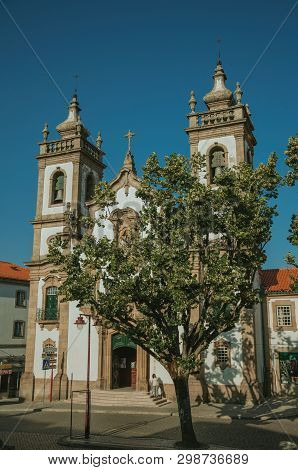 Guarda, Portugal - July 18, 2018. Church Of The Misericordia In Baroque Style And Leafy Tree On A Sq