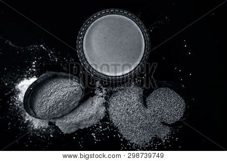 Clay Bowl On Wooden Surface Full Of Poppy Seeds Or Khus Or Opium Poppy Or Bread Seed Poppy With Its 