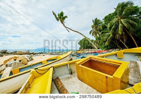 Small Fishing Canoes On The Sand Of Mahe, Glacis Beach, Seychelles Island