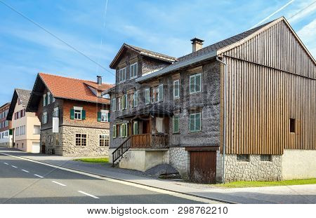 Residential Neighborhood In The Fall. View Of The Old Residential House Covered With Wooden Shingle.