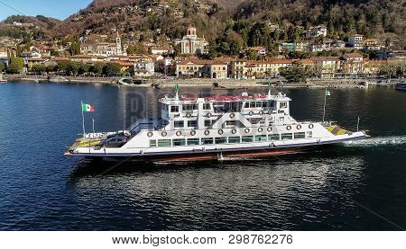Aerial View Of Ferry Boat That Leaves From The Port Of Laveno Mombello. Passenger Transport With Veh