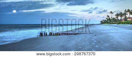 Moonset At Dawn Over A Dilapidated Pier On The Beach In Port Royal