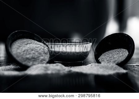 Clay Bowl On Wooden Surface Full Of Poppy Seeds Or Khus Or Opium Poppy Or Bread Seed Poppy With Its 