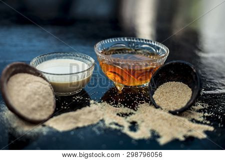 Clay Bowl On Wooden Surface Full Of Poppy Seeds Or Khus Or Opium Poppy Or Bread Seed Poppy With Its