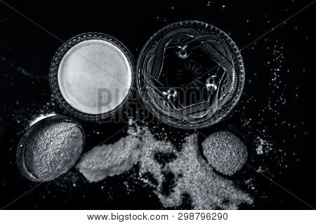 Clay Bowl On Wooden Surface Full Of Poppy Seeds Or Khus Or Opium Poppy Or Bread Seed Poppy With Its