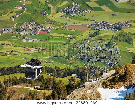 Mt. Stanserhorn, Switzerland - May 7, 2016: People In A Gondola Of The Stanserhorn Cabrio Aerial Cab