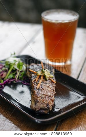 Marinated Grilled Barbecue Pork Rib With Salad And Pickled Vegetables Set With Michelada Cocktail Dr