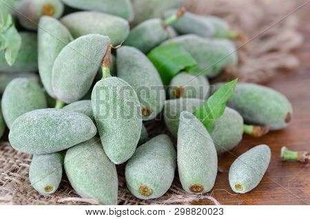 Stack Of Fresh Green Almond Nut Fruits On Table In The Kitchen.