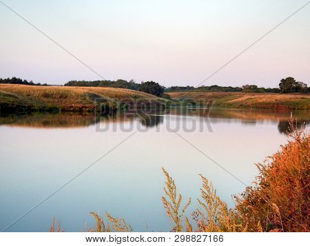 Summer Landscape, Early Morning, Steppe Lake And Its Shores In Reddish Color From The Rising Sun