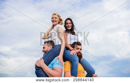 Men Carry Girlfriends On Shoulders. Summer Vacation And Fun. Couples On Double Date. Inviting Anothe