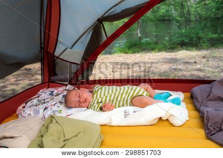 Cute Baby Boy Tourist Is Sleeping In A Tent In Summer Time Outdoors