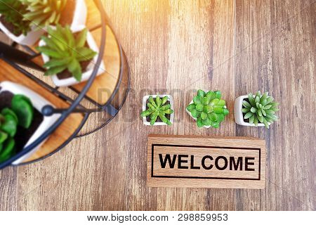 Warm Welcome Sign For Business Concept. Wooden Welcome Sign On Table Decorate With Little Cactus And