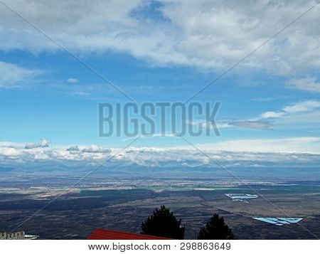 Top View Of Alazani Valley In Georgia In Springtime, In The Distance Through The Haze Visible To The