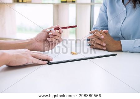 Husband And Wife Are Reading Divorce Agreement And Filing Pen To Signing Decree Of Divorce (dissolut