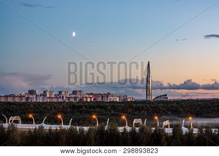 Evening Cityscape. View Of The Lakhta Center Tower In St. Petersburg In The Sunset With Clouds And M