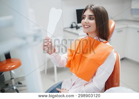 Dental Clinic. Reception,examination Of The Patient. Teeth Care. Young Girl Smiling, Looking In The 