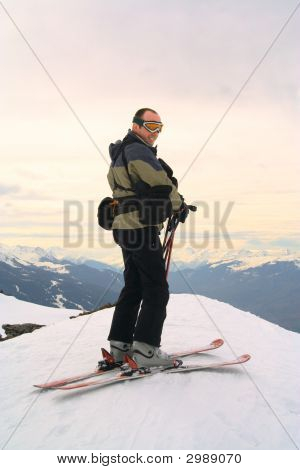 Skier On Peak Of The Mountain