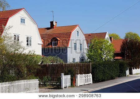 Block Of Two Story Single Family Wooden Houses With Mansard Roofs Erected Duringthe 1920s Era.