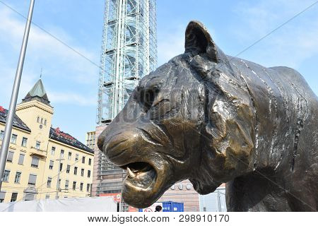 Oslo, Norway: April 2019 -  Oslo Bus And Train Station House With Tiger Statue   Next To The Entranc