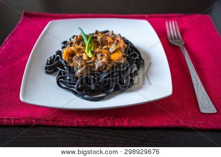 Black Pasta With Cuttlefish Ink. Pasta Of Durum Wheat Semolina With Squid Ink With Beef And Sweet Pe