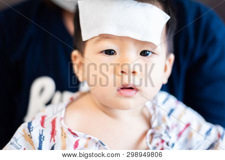 Unhappy Asian Little Baby Sick With Cool Fever Jel Pad On Forehead