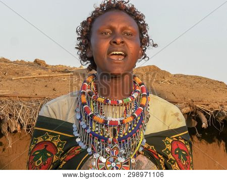 Close Up Of A Maasai Woman In Green Singing