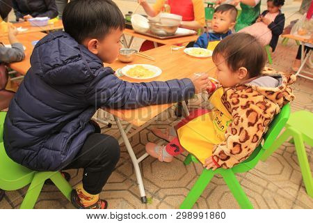 Hanoi, Viet Nam - March 11, 2018: Lovely Elder Brother Is Feeding For His Younger Sister In One Fair
