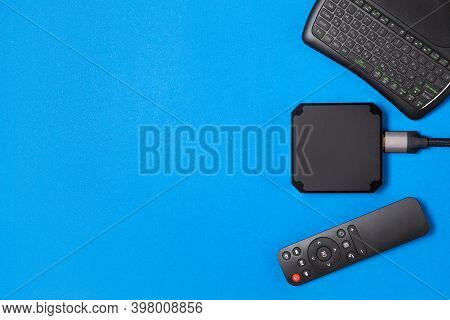 Tv Box And Remote Controls For Ip Tv And Digital Video Content On A Blue Background