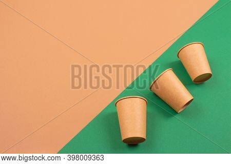 Set Of Eco-friendly Takeaway Beverages Cups - Kraft Paper Coffee Cups On Green And Brown Background 