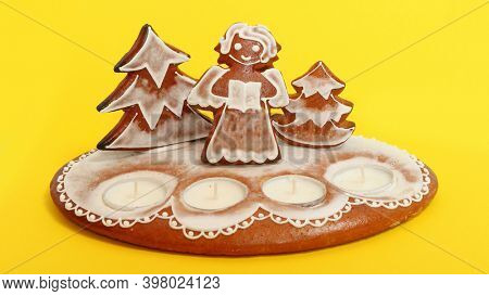 Pardubice - Czech Republic - December 4, 2020: Traditional handmade gingerbread candle stand on yellow background. Christmas craft product from Bohemia. 