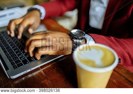 African American Man Getting Online Education And Drinks Coffee To Go Frop Paper Eco Cup