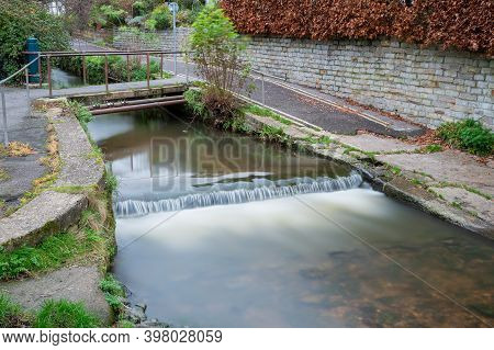 Long Exposure Of A Watefall On The River Lim Walkway At Lyme Regis In Dorset.