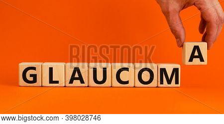 Glaucoma Symbol. Wooden Cubes With Word 'glaucoma'. Male Hand. Beautiful Orange Background. Medical 