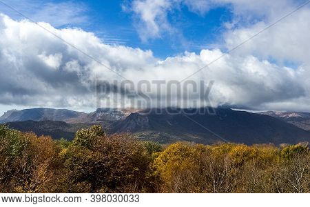 Mountains And Forests Of Crimea. Coniferous And Deciduous Trees On The Hills Of The Mountains And Ro