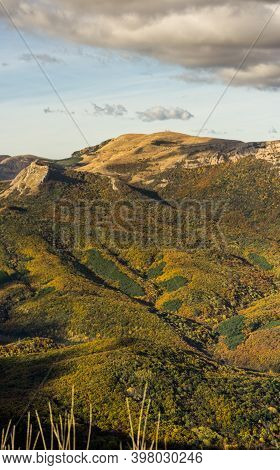 Mountains And Forests Of Crimea. Coniferous And Deciduous Trees On The Hills Of The Mountains And Ro